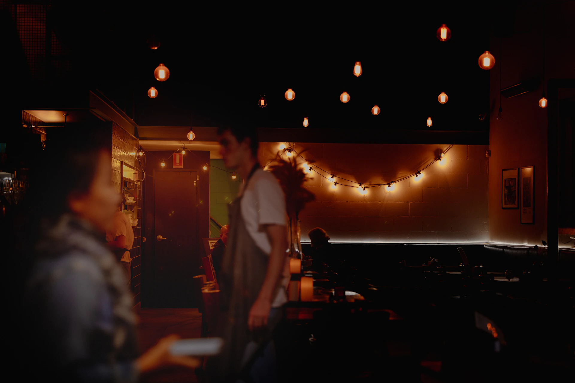 Warm lighting revealing a happy family enjoying a luxurious meal together in the stylish interior of foodface restaurant & cafe.