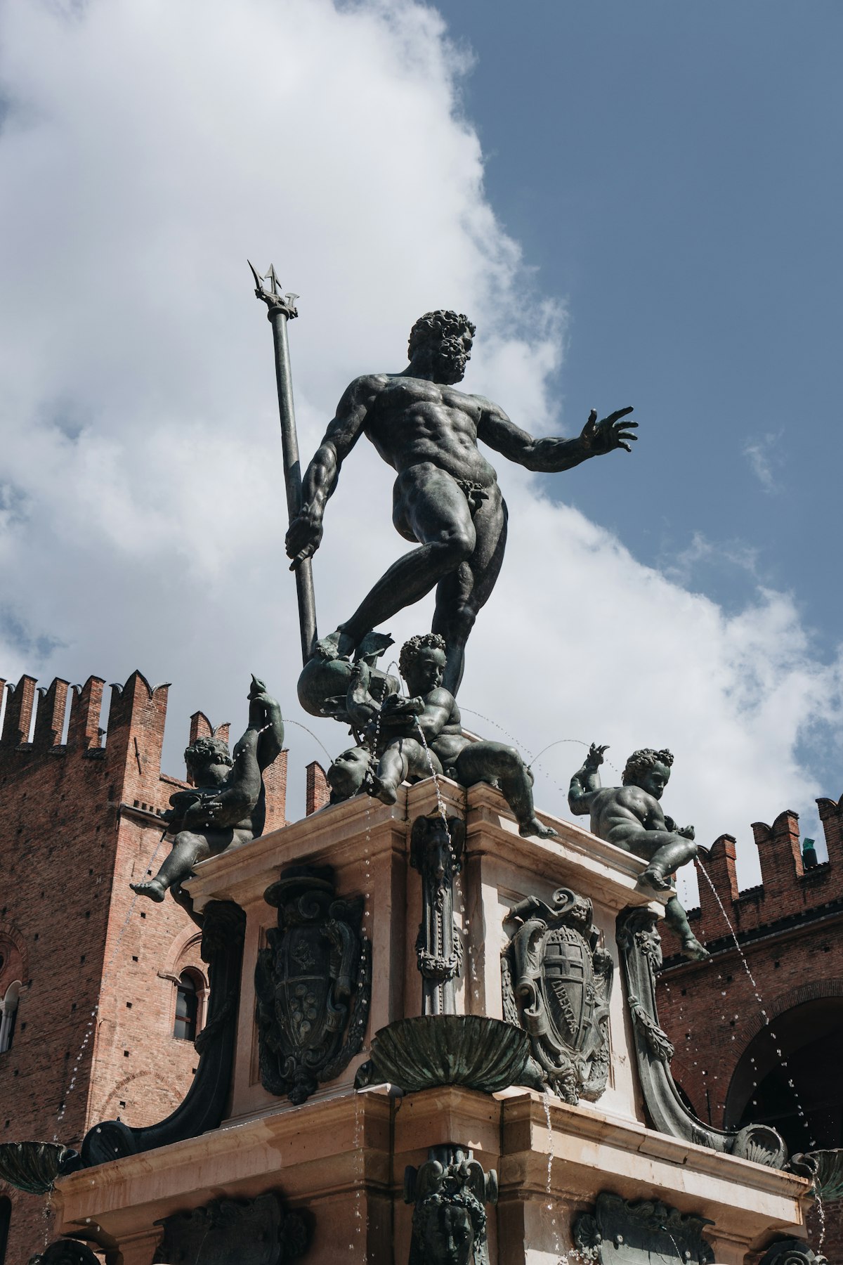 Bologna March — Neptune fountain statue in Piazza Maggiore in spring