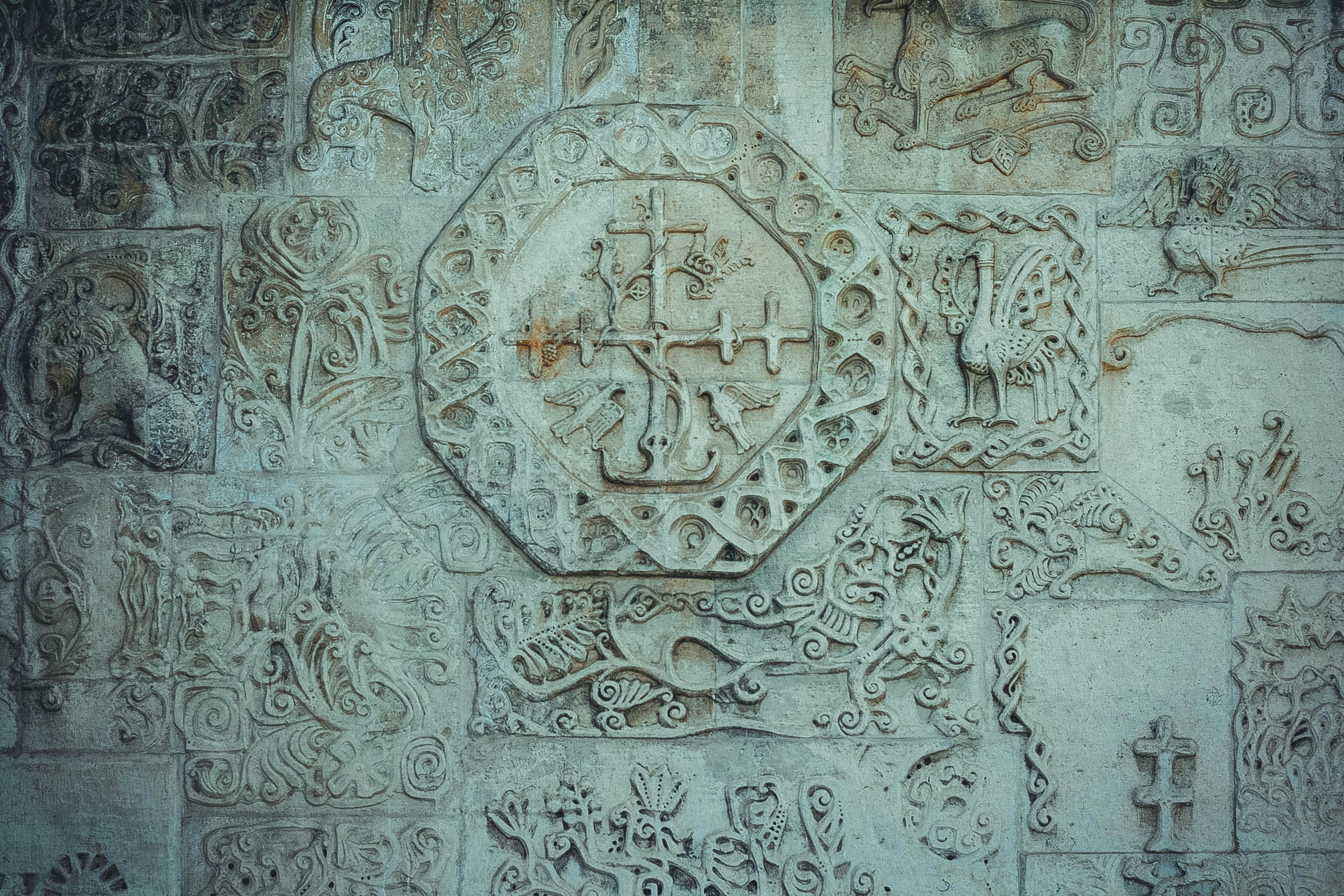 a close up of a stone wall with carvings on it, 