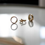 Elegant gold rings stacked together, highlighting their intricate designs and shine.