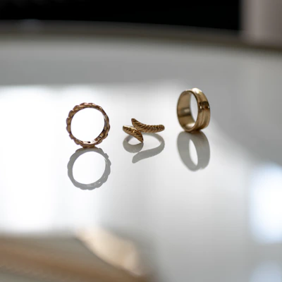 Elegant gold rings stacked together, highlighting their intricate designs and shine.