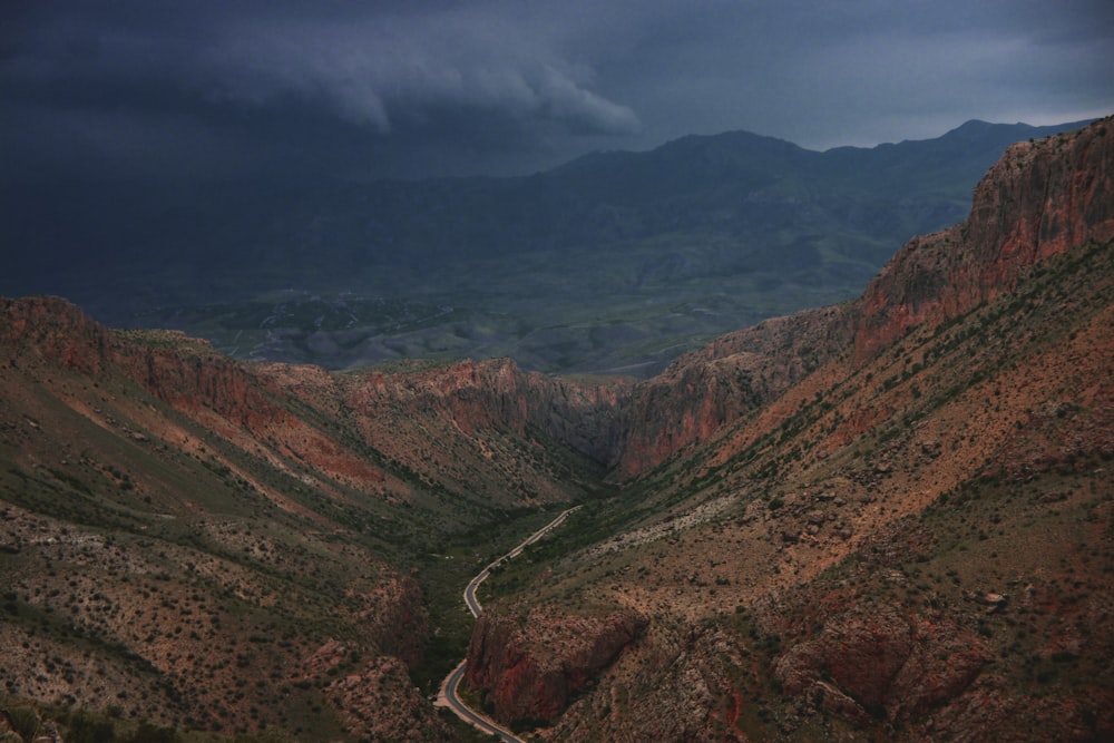 a road winding through a valley surrounded by mountains