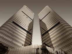 a couple of tall buildings sitting next to each other