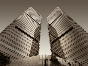 a couple of tall buildings sitting next to each other