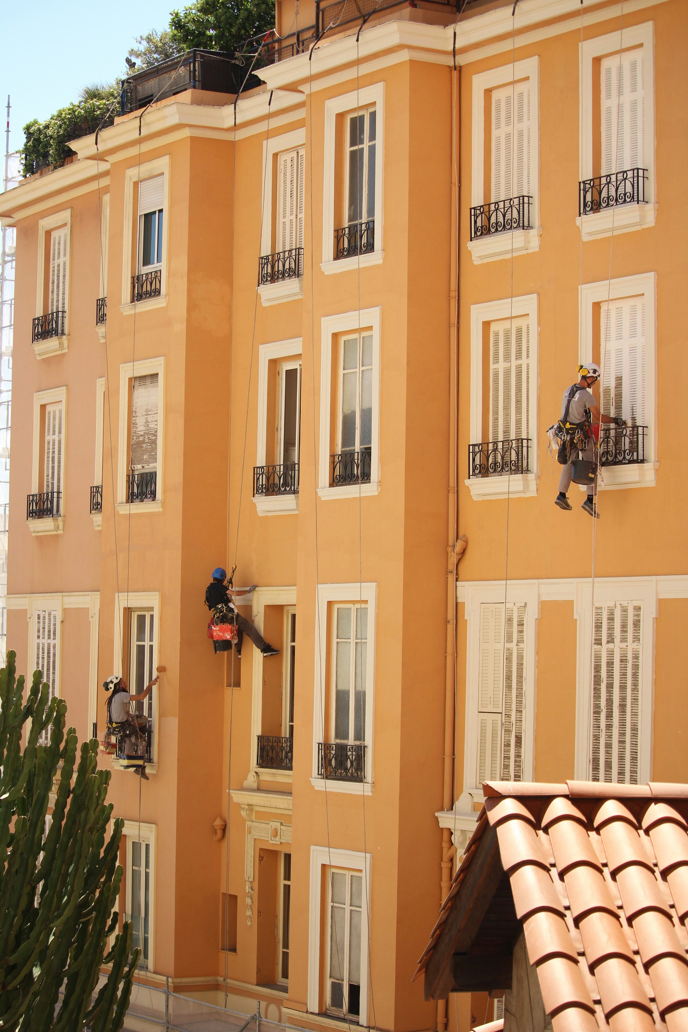 a man on a ladder working on a building