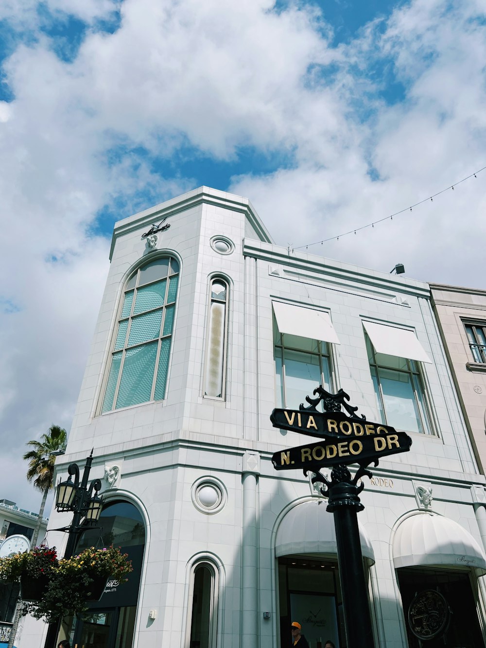 a white building with a street sign in front of it