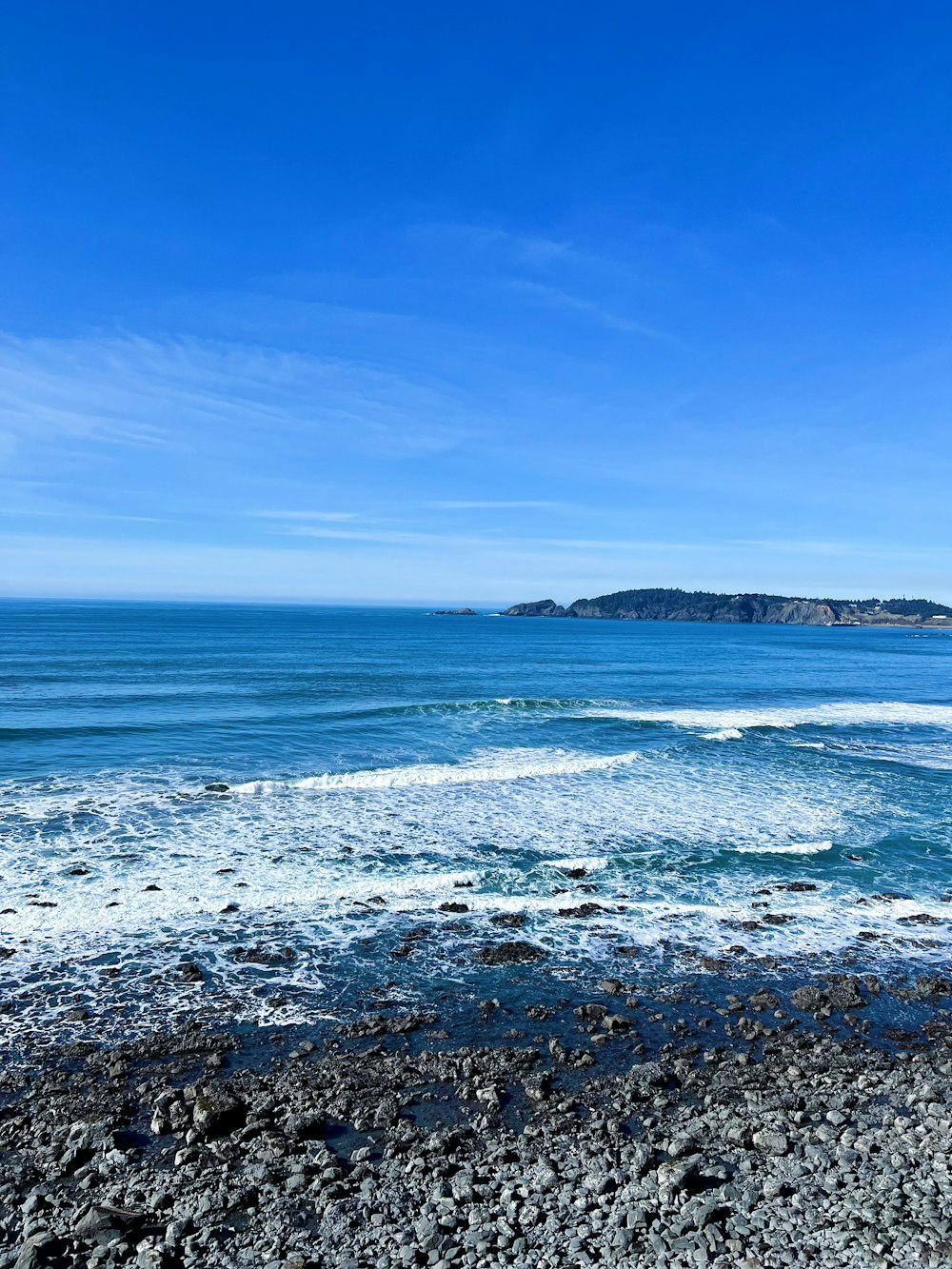 a view of the ocean from a rocky beach