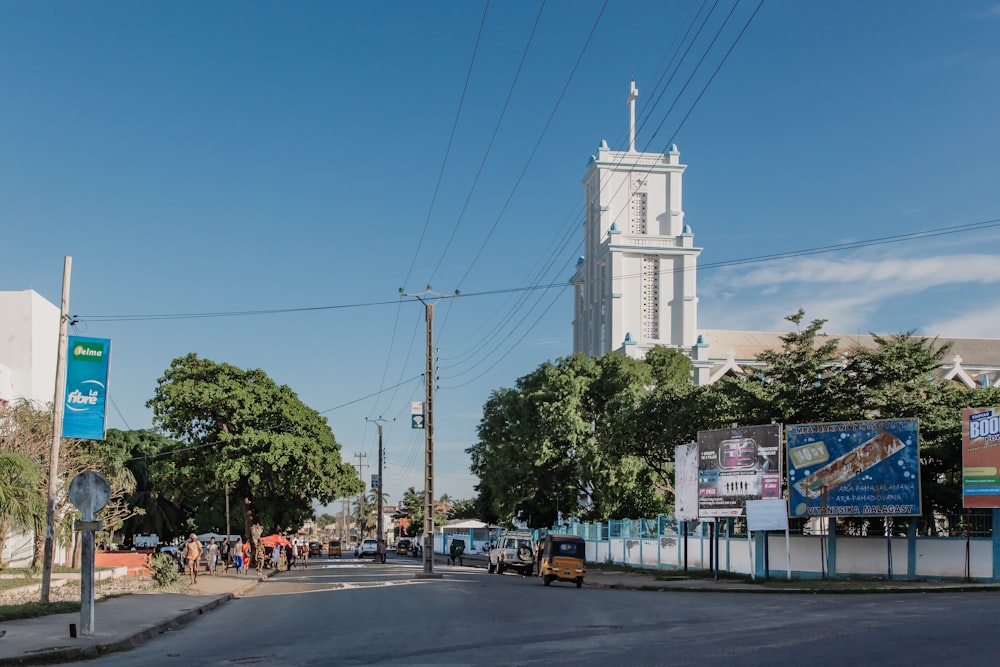 a city street with a church steeple in the background