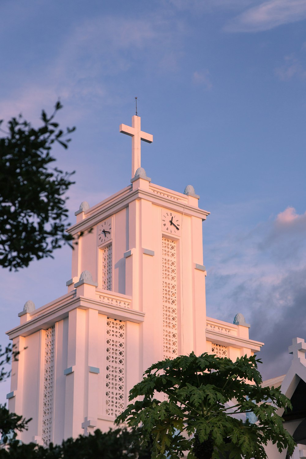 a white church with a cross on the top of it