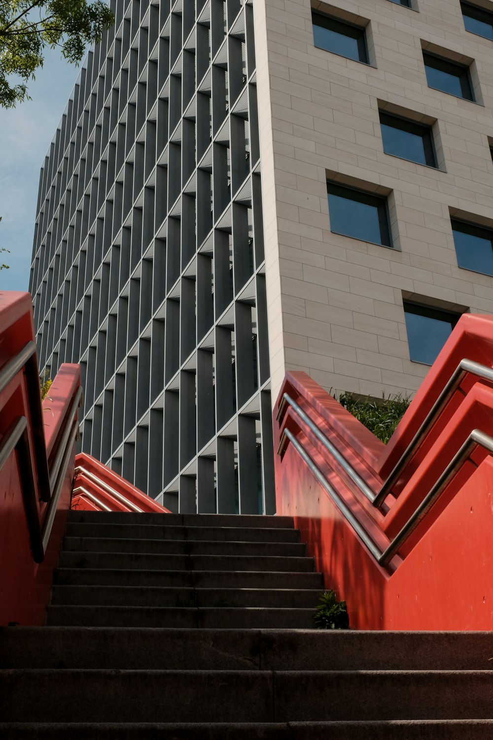 a red staircase leading up to a tall building