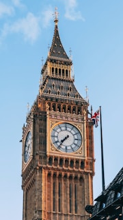 a large clock tower with a sky background