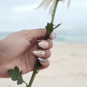 Bright summer-inspired nail art featuring tropical colors and tiny flower details.