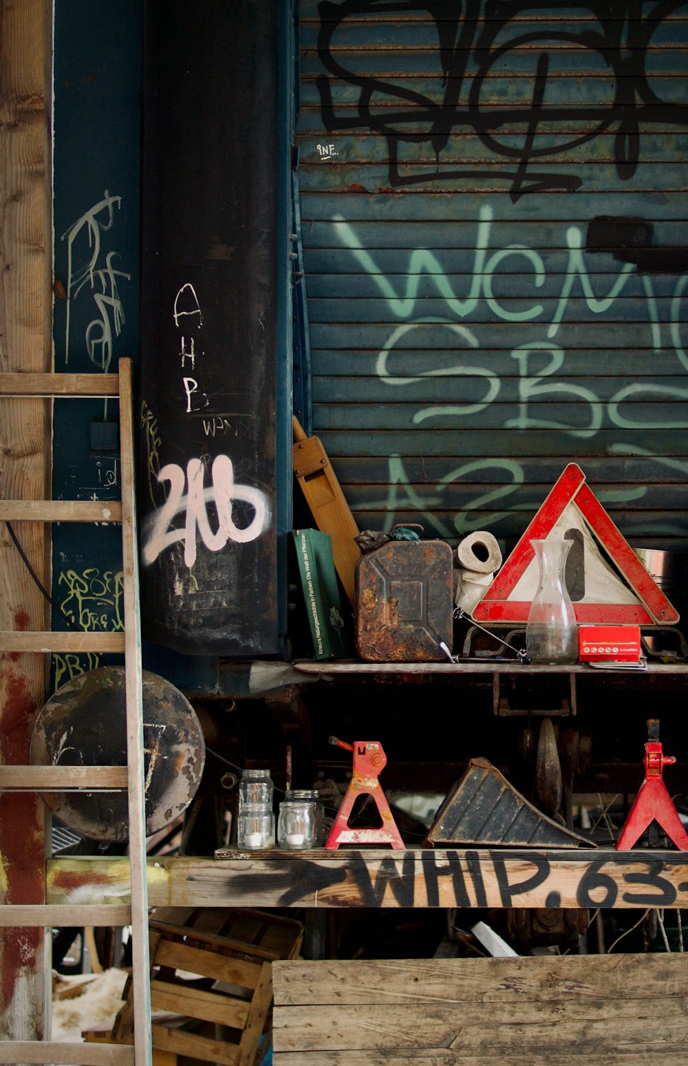 a ladder leaning against a building with graffiti on it