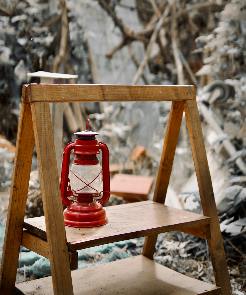 a red lantern sitting on top of a wooden chair