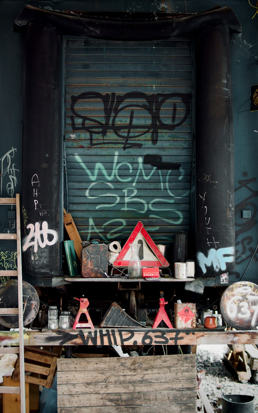 a room with a bunch of graffiti on the wall