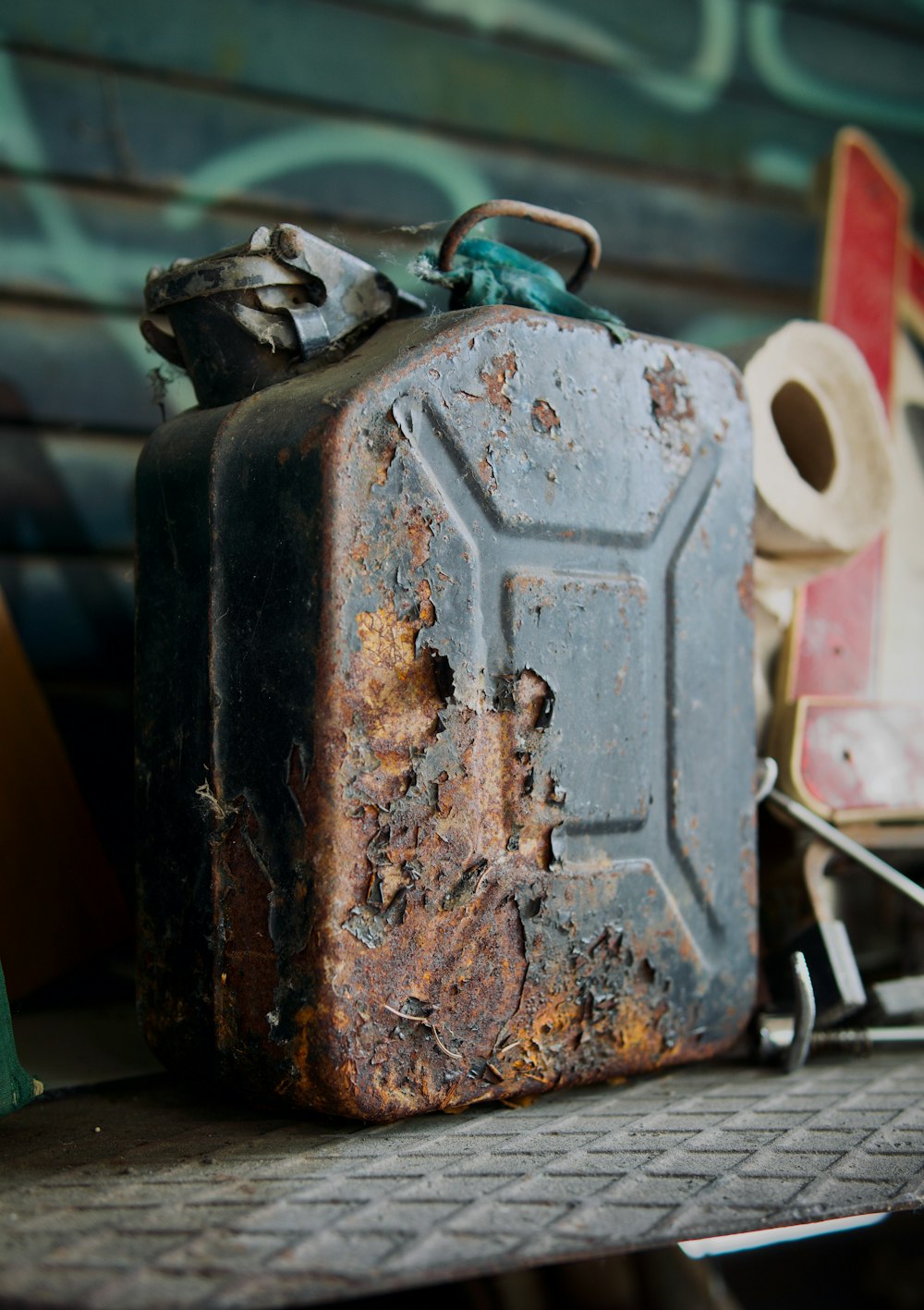 a rusted metal container sitting on top of a table