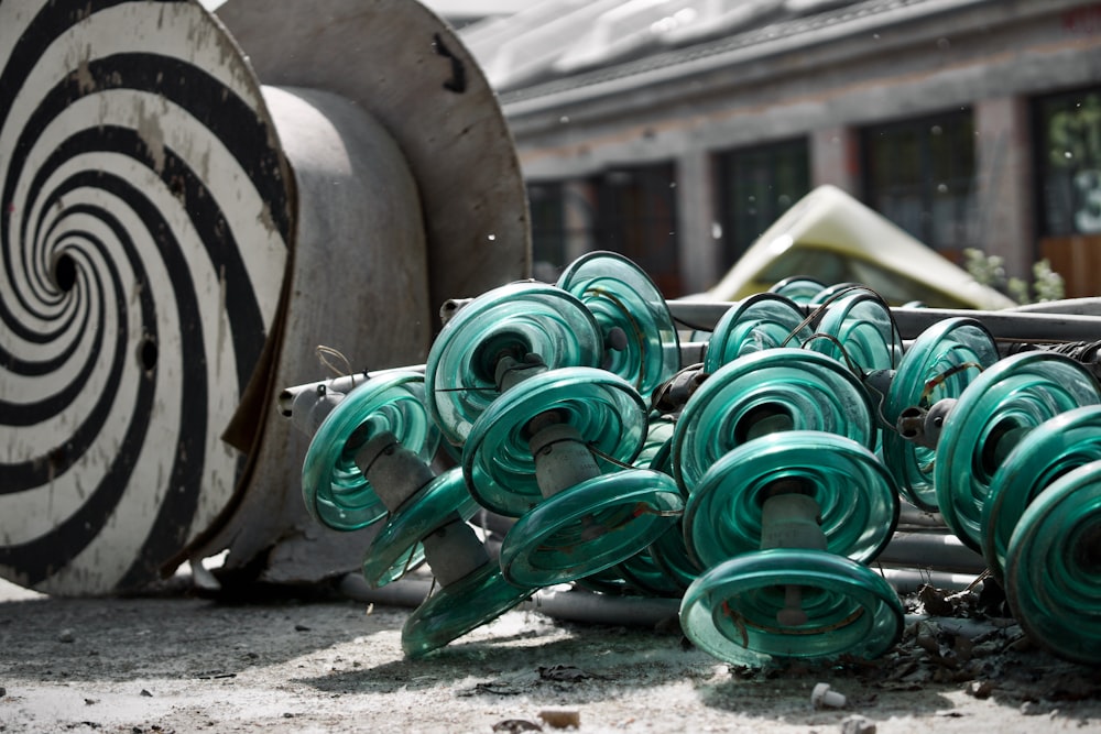 a pile of green hoses sitting next to a building