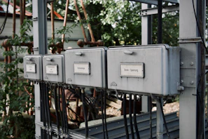 a row of electrical boxes sitting on top of a metal structure