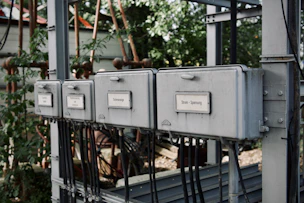 a row of electrical boxes sitting on top of a metal structure