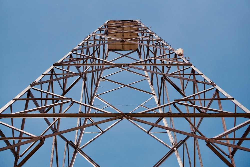 a tall metal tower with a blue sky in the background