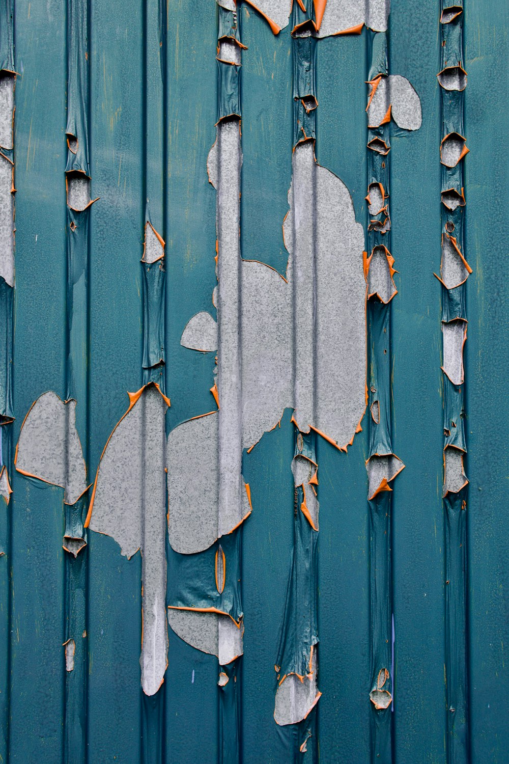 a blue wall with peeling paint on it