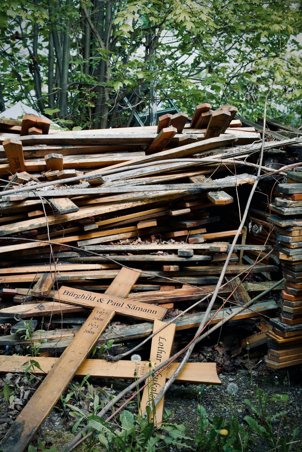 a pile of wood with a cross on top of it