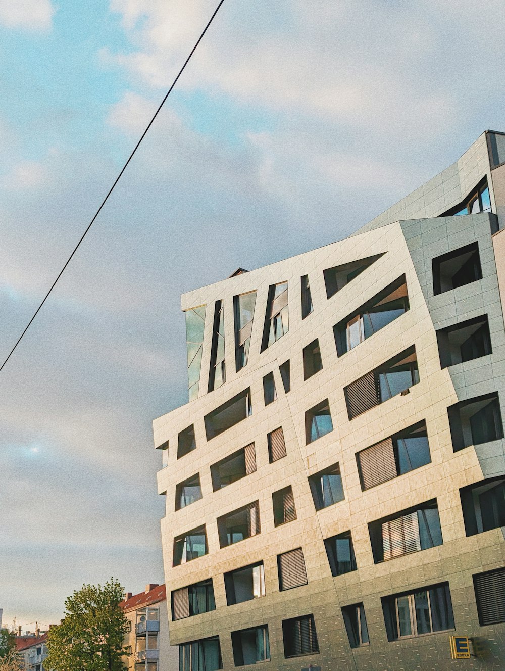 a tall building with a lot of windows next to a street