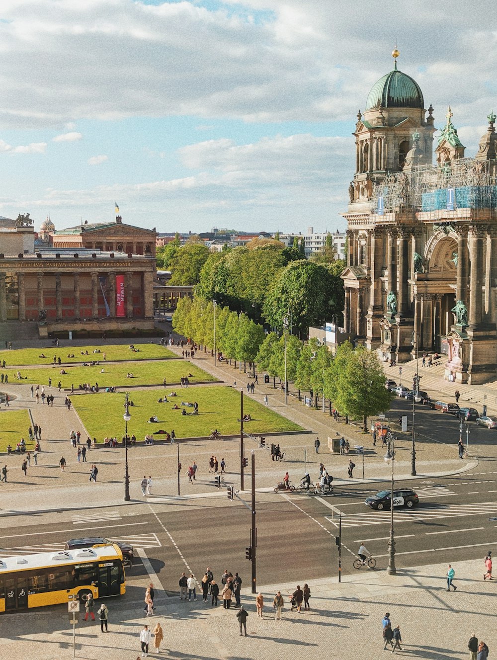 a group of people walking around a city square