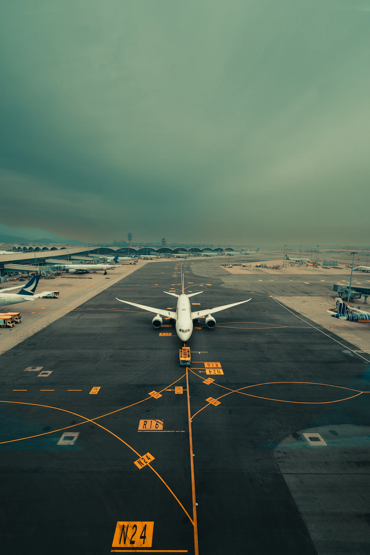 Large jetliner parked on an airport apron under a clear sky