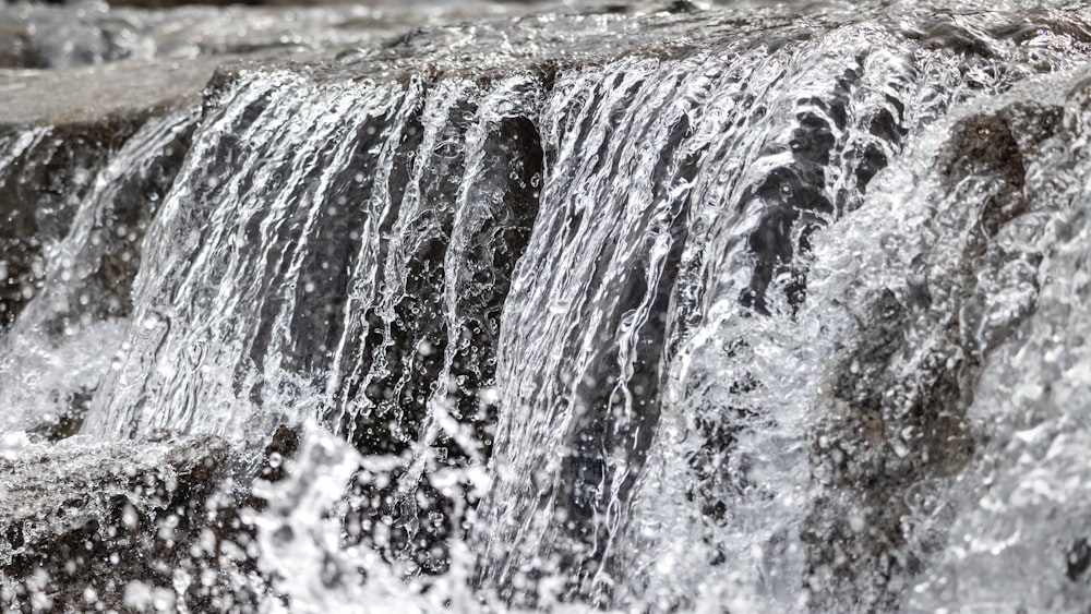 a close up of a waterfall with water coming out of it