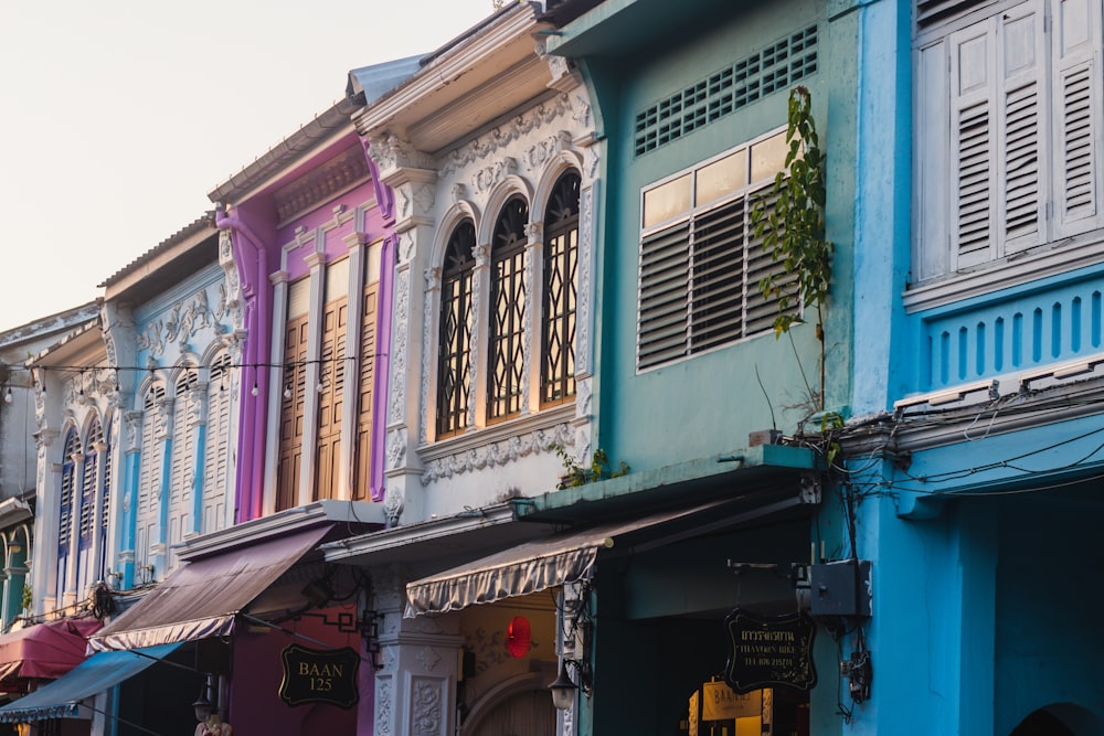 a row of multicolored buildings on a city street