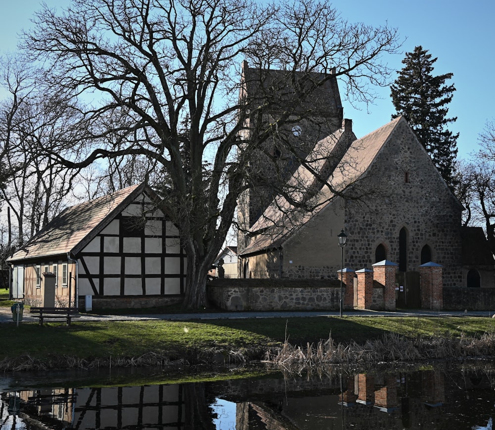 an old church with a pond in front of it