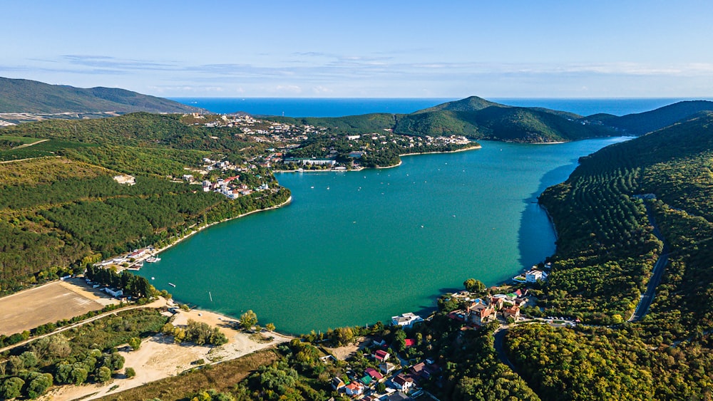 an aerial view of a lake surrounded by mountains