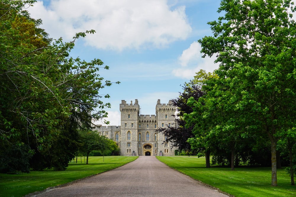 a long driveway leading to a large castle