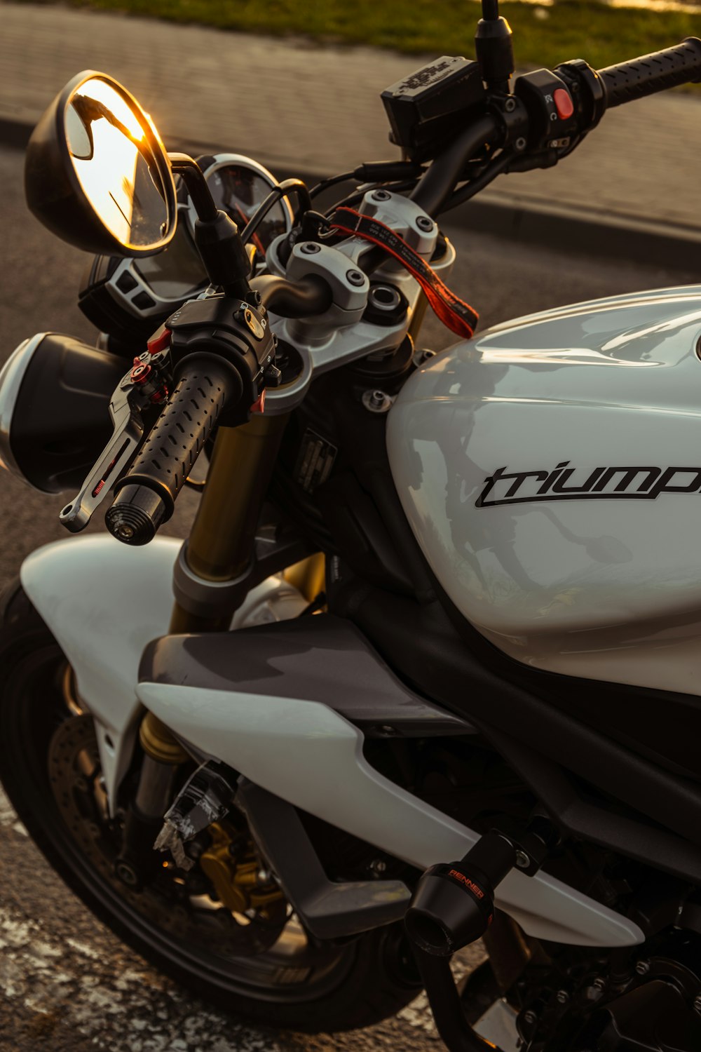 a white and black motorcycle parked on the side of the road