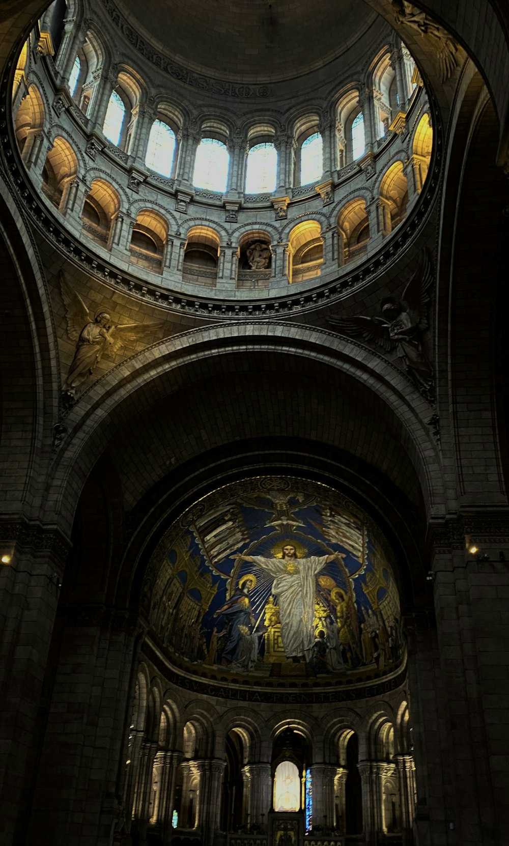 the inside of a church with a dome and stained glass windows