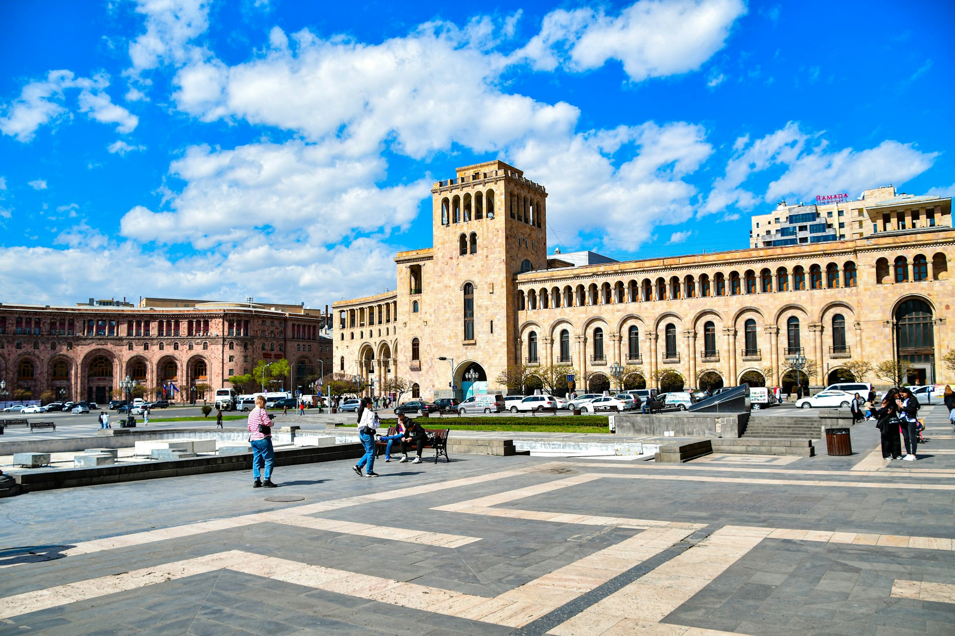 a group of people walking around a large building