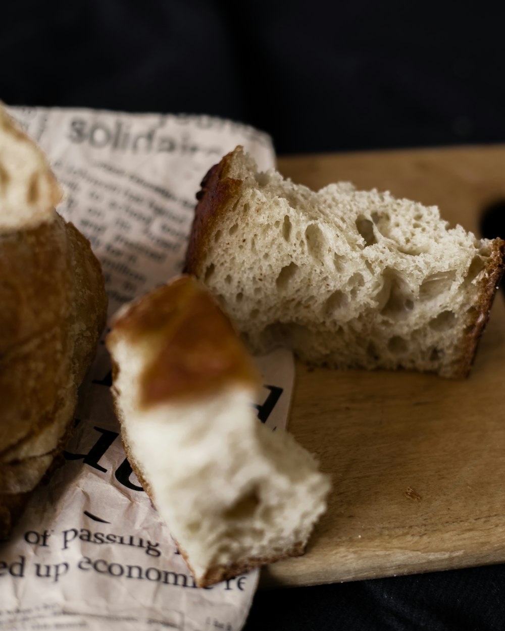 a loaf of bread sitting on top of a wooden cutting board