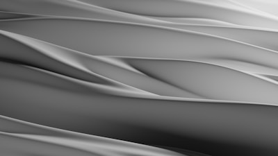 Smooth, flowing abstract patterns create a serene and minimalist aesthetic. The soft curves and gradients suggest a sense of movement and calm.