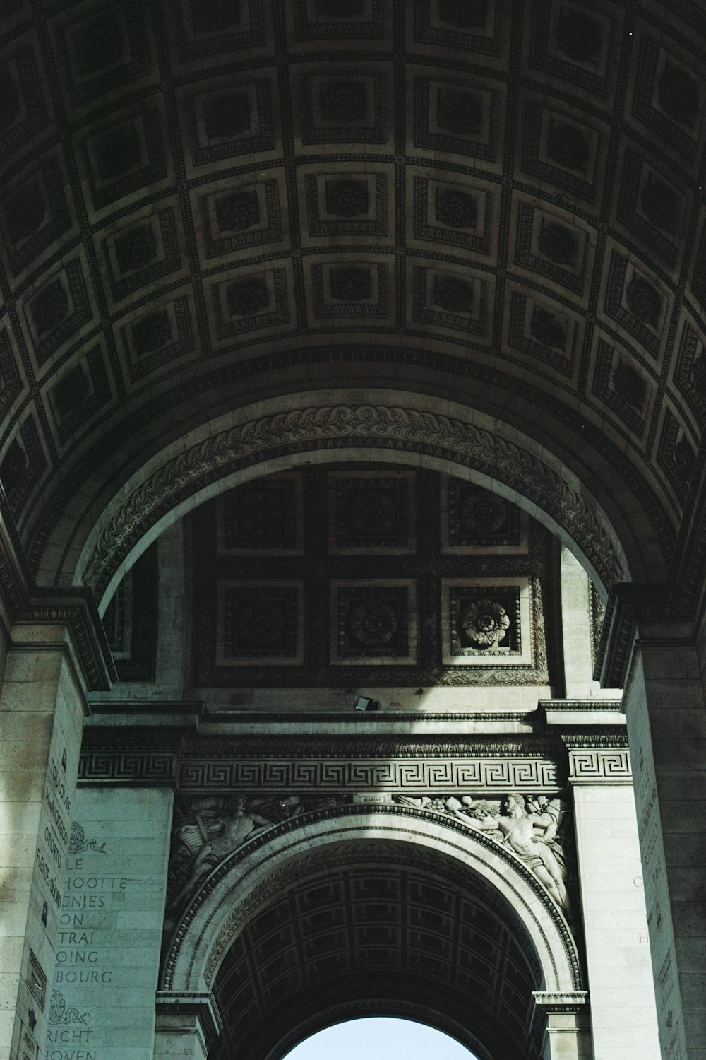 an arch with a clock on the side of it