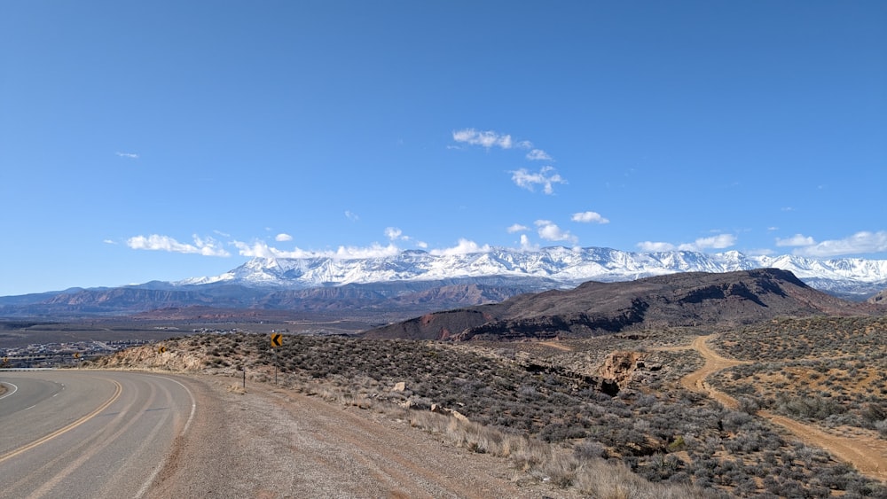 a view of a road with mountains in the background