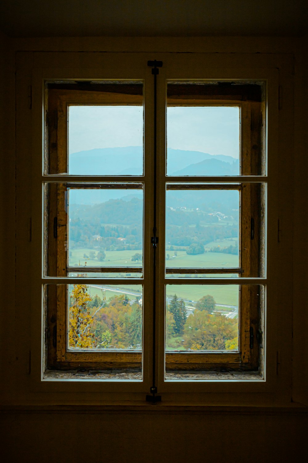 a window with a view of a valley