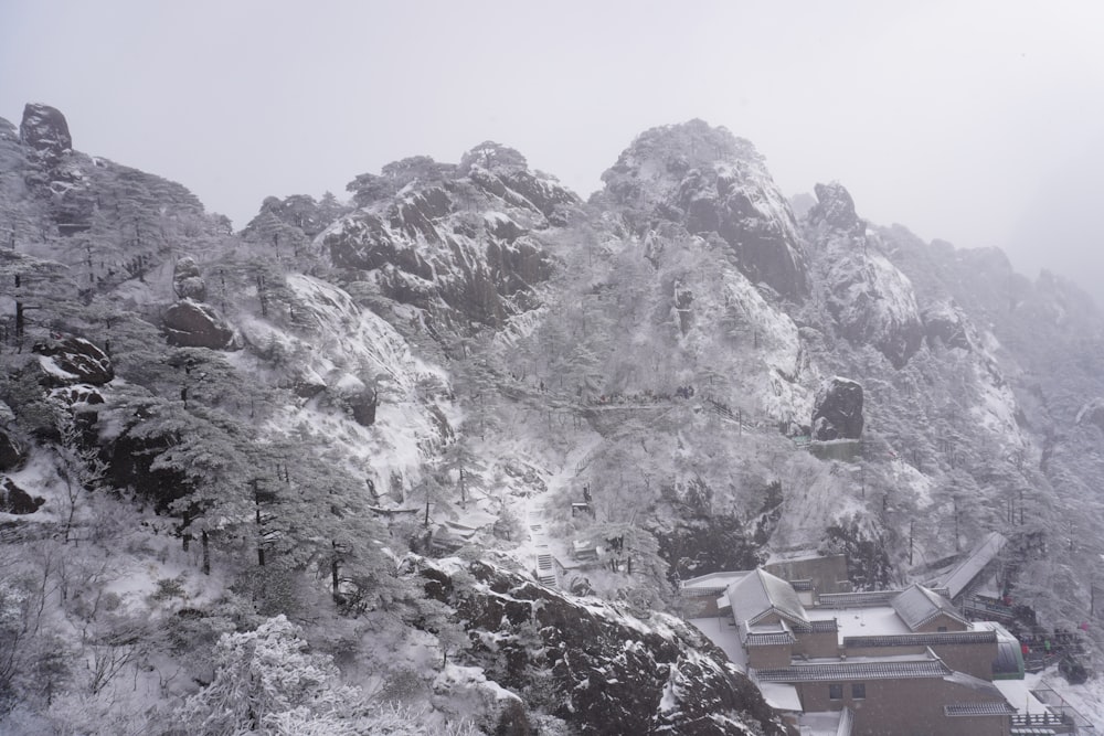 a snow covered mountain with houses on it