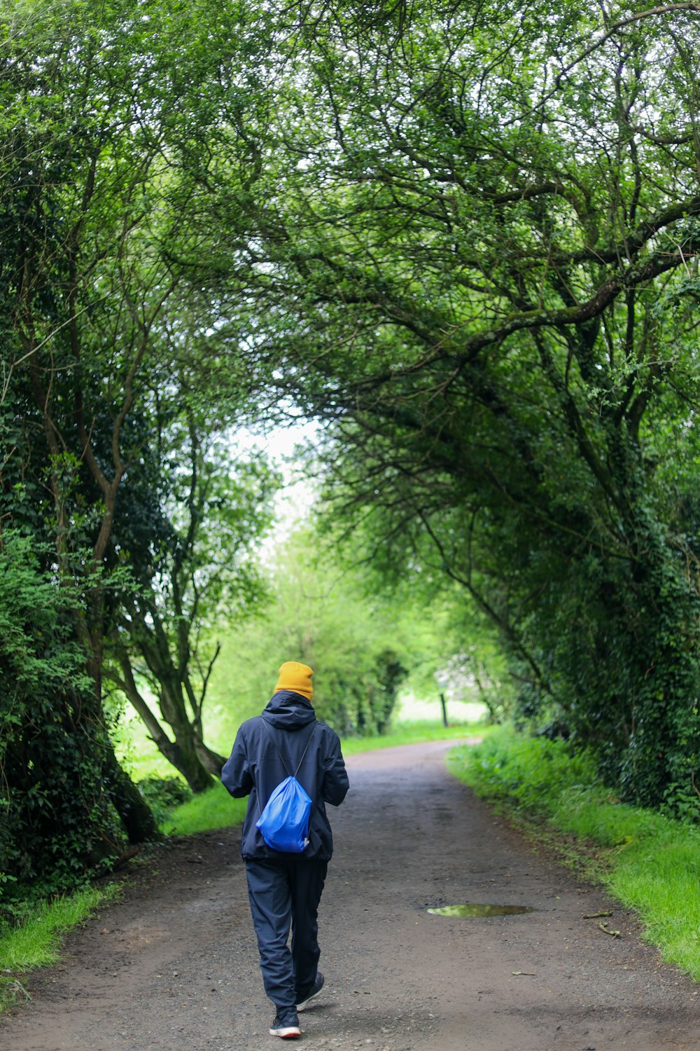 a person walking down a road with a backpack