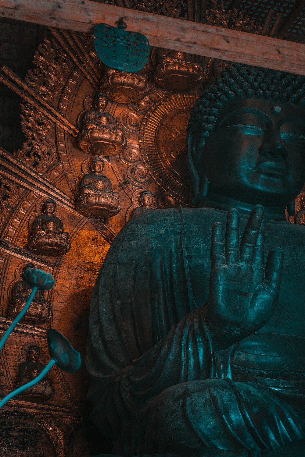 a statue of a buddha in front of a wall