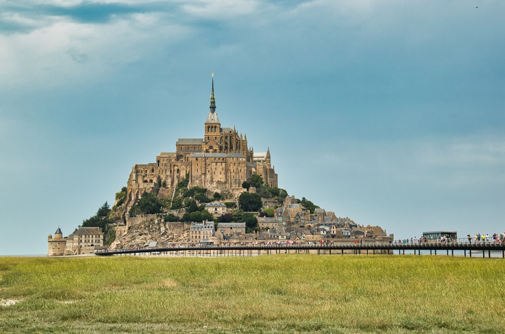 a very tall castle sitting on top of a lush green field