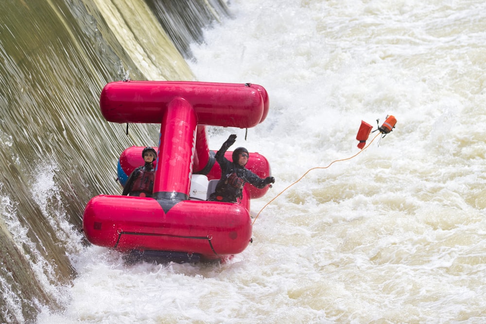 a group of people riding on top of a raft down a river