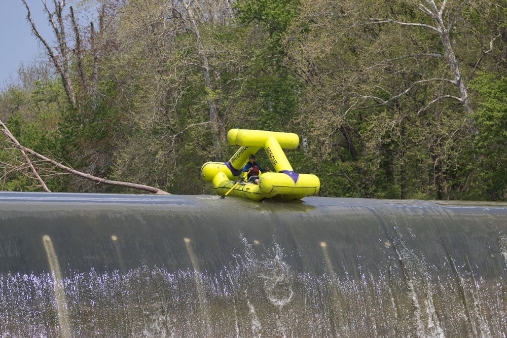 a yellow raft sitting on top of a metal pipe