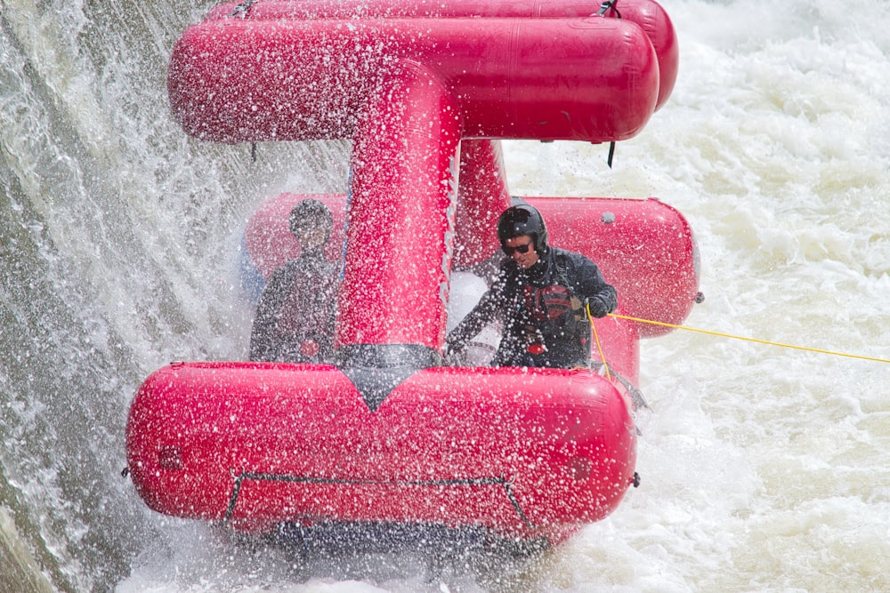 a man riding a raft down a river