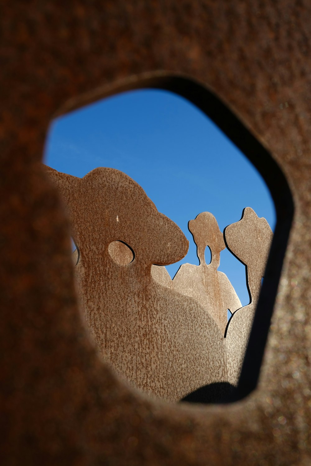 a close up of a metal object with a sky in the background